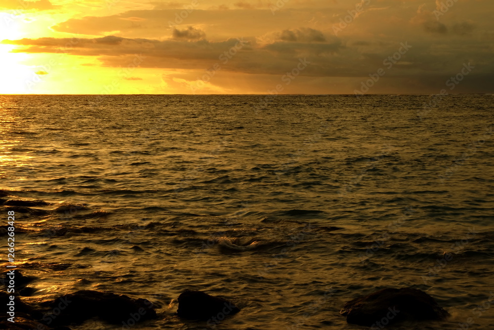 the beauty of panati Kuta Bali at dusk, with stunning orange and gold colors the beauty of panati Kuta Bali at dusk, with stunning orange and gold colors