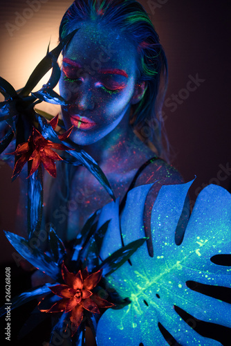 Fototapeta Naklejka Na Ścianę i Meble -  Woman model in neon paints with ultraviolet lamps