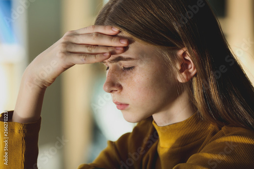 Sad teenage girl at home