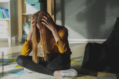 Sad teenage girl at home