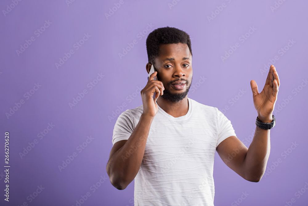 Studio portrait of american man posing with smartphone Studio portrait of american man posing with smartphone