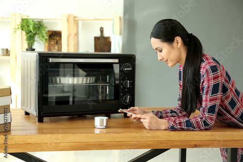 Young Asian woman with tabl...
