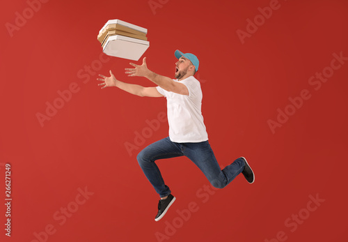 Jumping male courier with p...