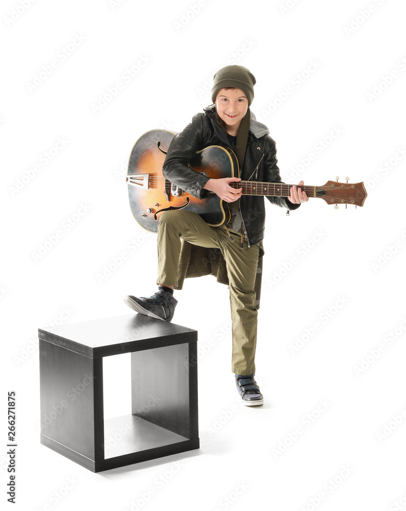 Naklejka premium Cool little boy with guitar on white background