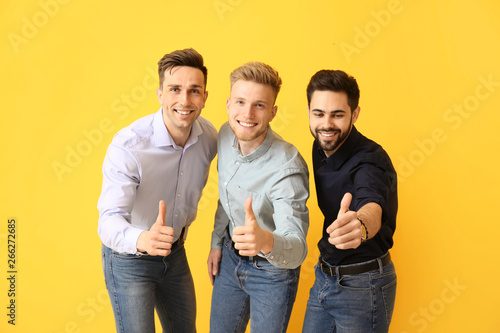Happy young men showing thu...
