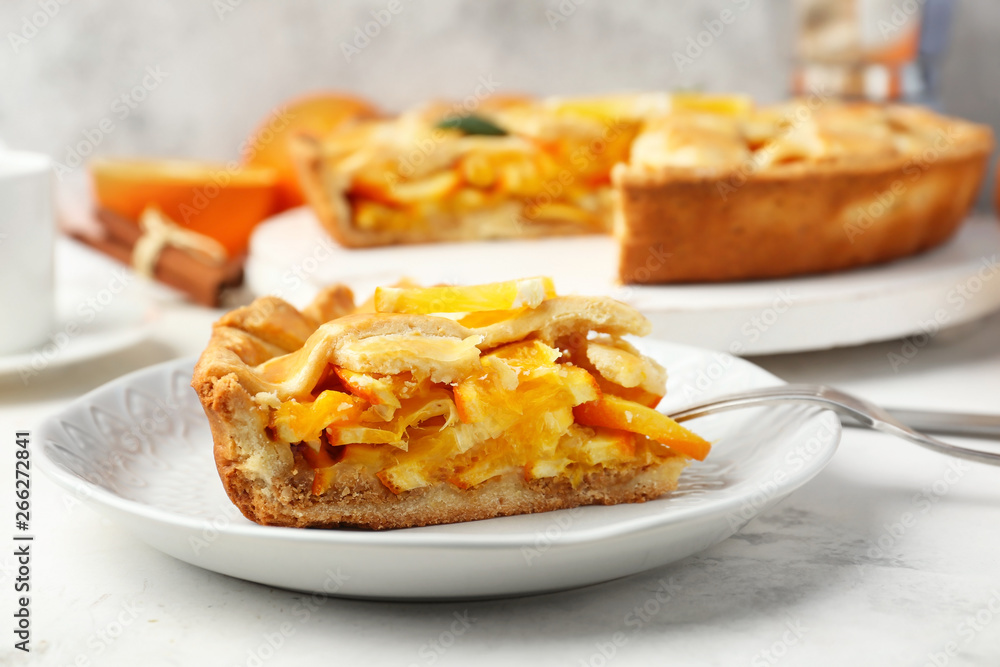 Plate with piece of tasty orange pie on table Plate with piece of tasty orange pie on table