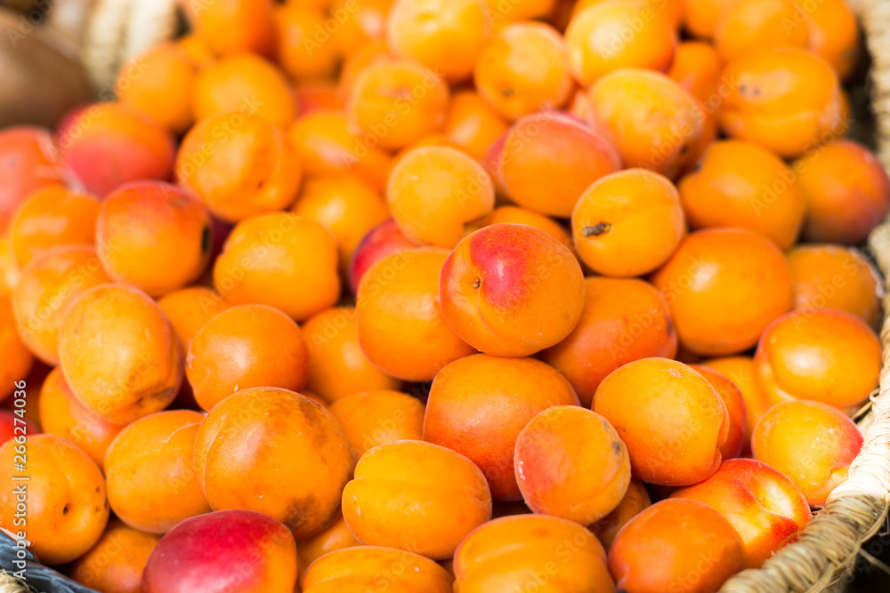 appetizing apricots in wicker baskets on counter in market appetizing apricots in wicker baskets on counter in market