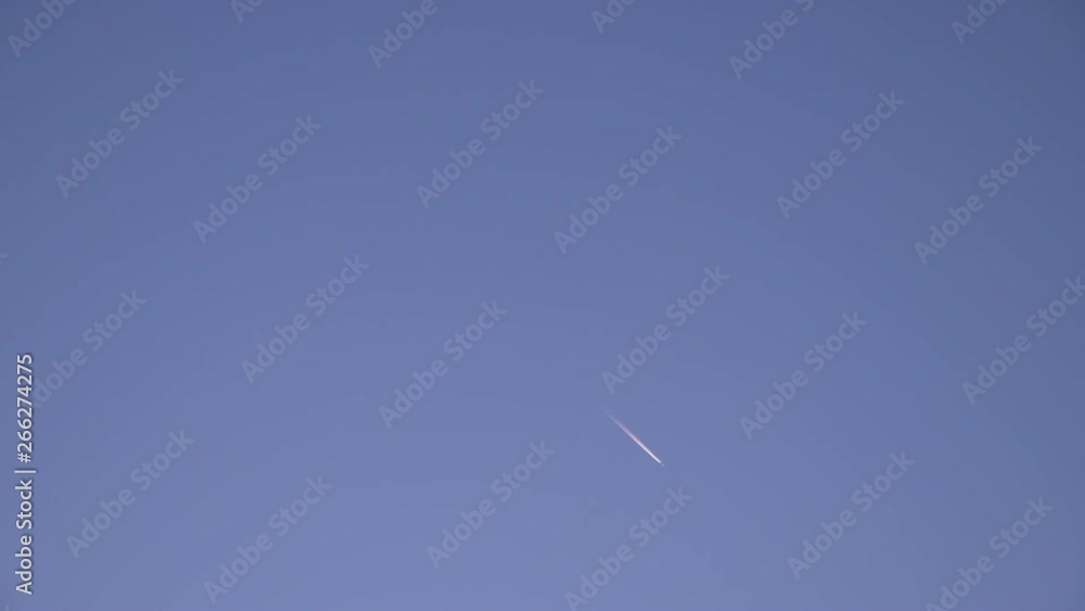 4K Contrail Of Airplane Speeding Across Blue, Cloudless Sky. 4K Contrail Of Airplane Speeding Across Blue, Cloudless Sky.