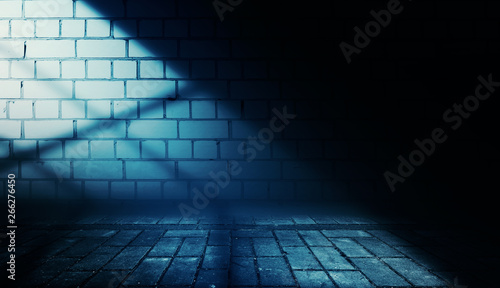 Empty scene background. Incident light from a window on an empty brick wall. Dark abstract background