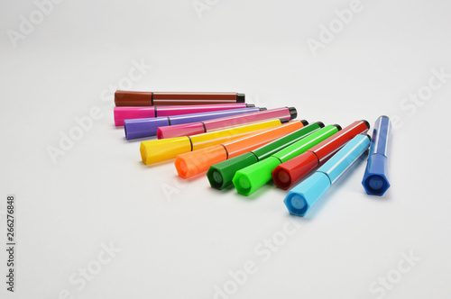 Multi colored felt tip pens on white background