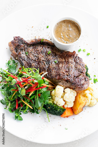 premium beef steak with steamed vegetables meal on white plate