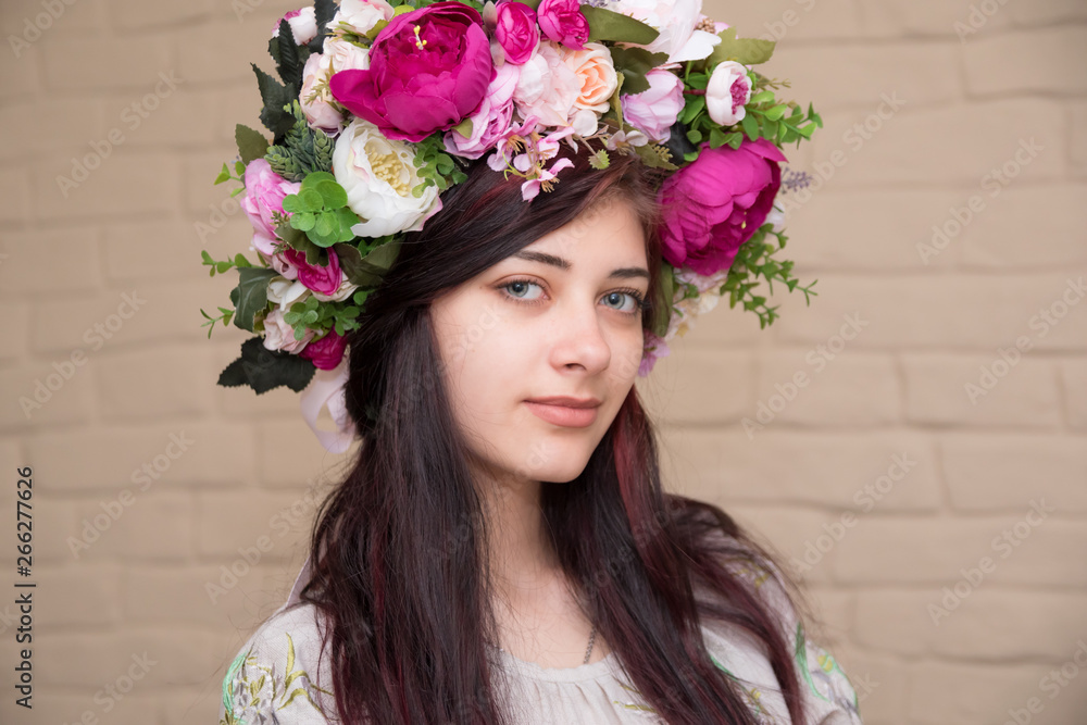 Portrait of a girl with a corolla on her head. Wreath - Traditional Ukrainian headdress of girls.