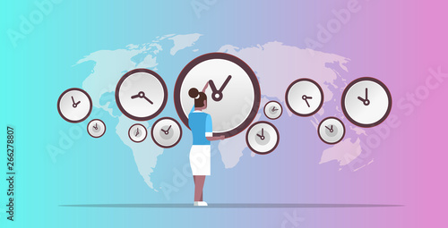 businesswoman pointing on wall with clocks different cities time management deadline concept african ameriscan business woman over world map background horizontal full length