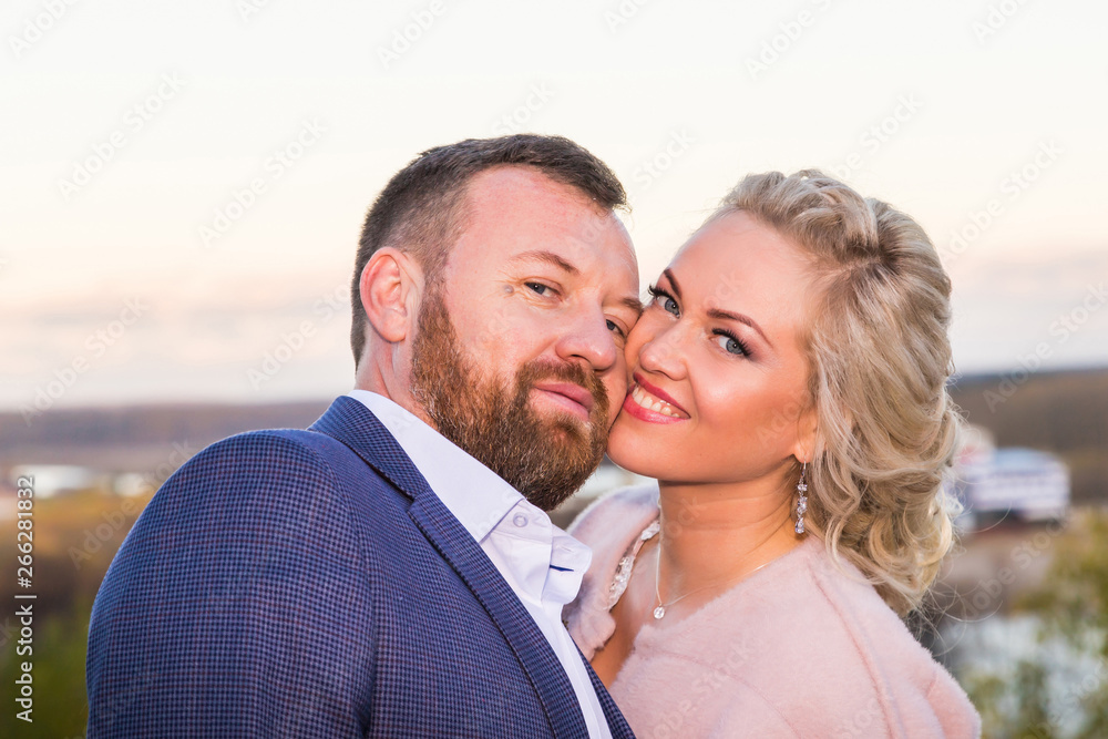 Fototapeta premium International bride and groom together in green city park
