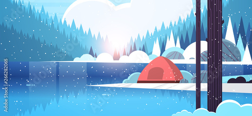 tent camping area in forest campsite near river winter camp travel vacation concept snowfall sunrise landscape nature background with water mountains and hills flat horizontal