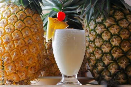 The Pina Colada is a sweet cocktail made with rum, coconut cream or coconut milk, and pineapple juice. It may be garnished with either a pineapple wedge, maraschino cherry, or both.