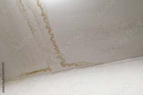 Rainwater leaks from the roof cause damage to the ceiling and tiles and gypsum board ,empty space for text.