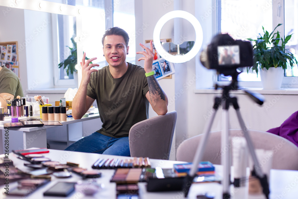 Talkative dark-haired man actively gesturing on camera Talkative dark-haired man actively gesturing on camera