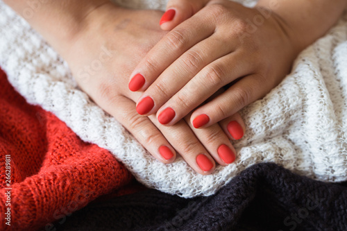 Closeup photo of a beautiful female hands with red nails