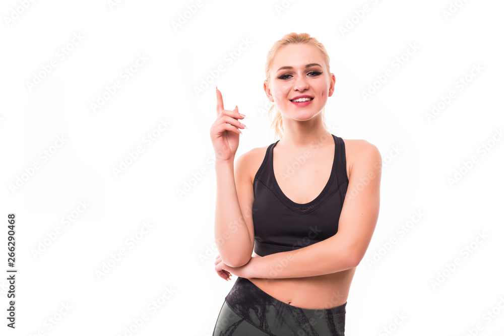 Portrait of a fitness woman pointing fingers up isolated on white background Portrait of a fitness woman pointing fingers up isolated on white background