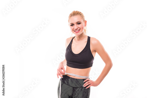 Smiling fitness woman measuring waist with tape isolated on a white background