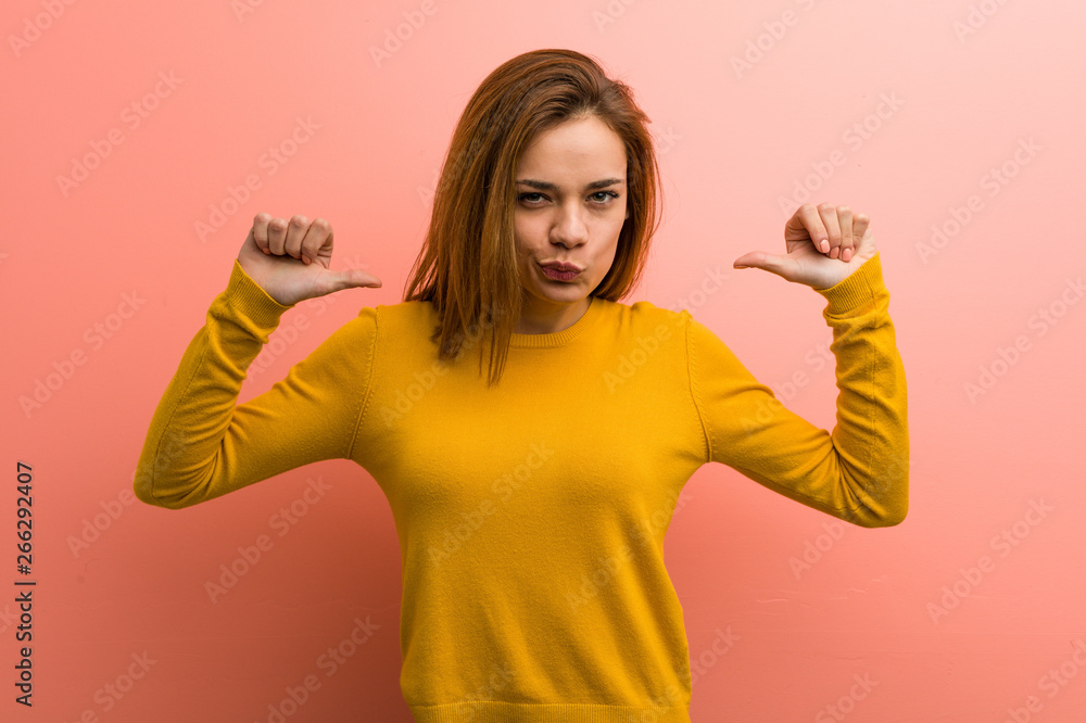Young pretty young woman feels proud and self confident, example to follow. Young pretty young woman feels proud and self confident, example to follow.