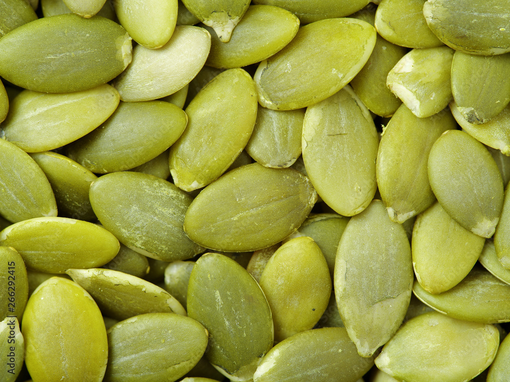 Macro background texture of green pumpkin seeds Macro background texture of green pumpkin seeds