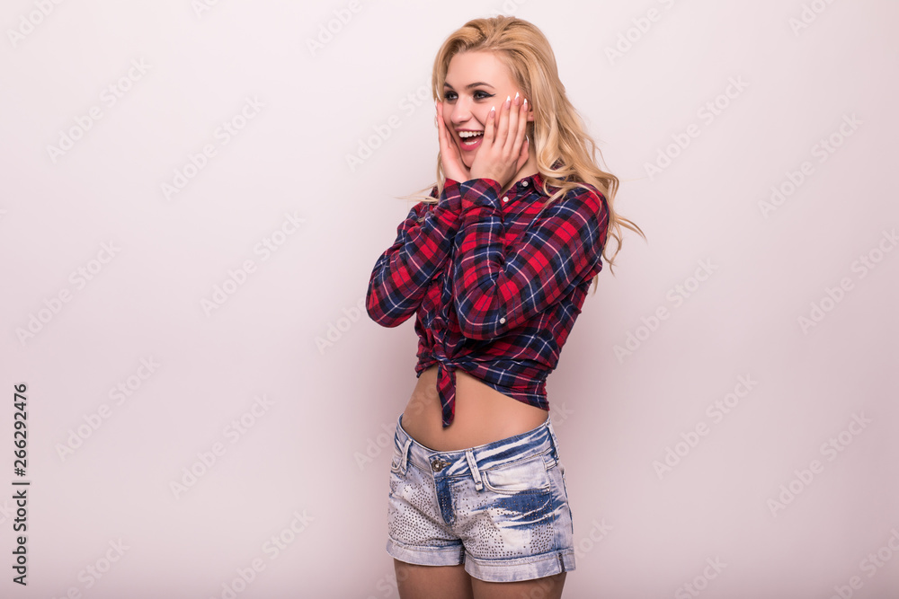 Close up portrait of pretty surprised woman with opened mouth in checkered shirt isolated on gray background Close up portrait of pretty surprised woman with opened mouth in checkered shirt isolated on gray background