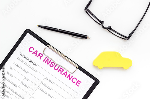 Car buying and insurance concept with car figure and form on white background top view