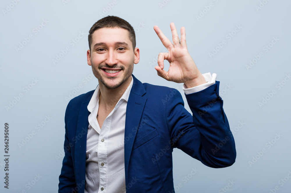 Young business caucasian man cheerful and confident showing ok gesture. Young business caucasian man cheerful and confident showing ok gesture.