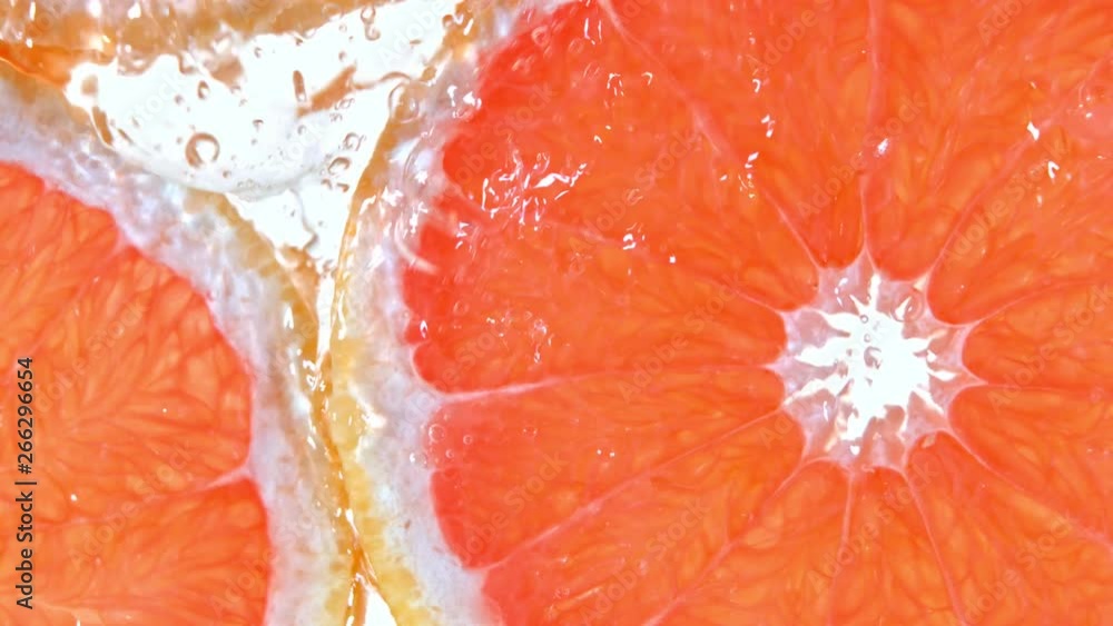 Super Slow Motion Shot of Splashing Water to Grapefruit Slices at 1000fps. Super Slow Motion Shot of Splashing Water to Grapefruit Slices at 1000fps.
