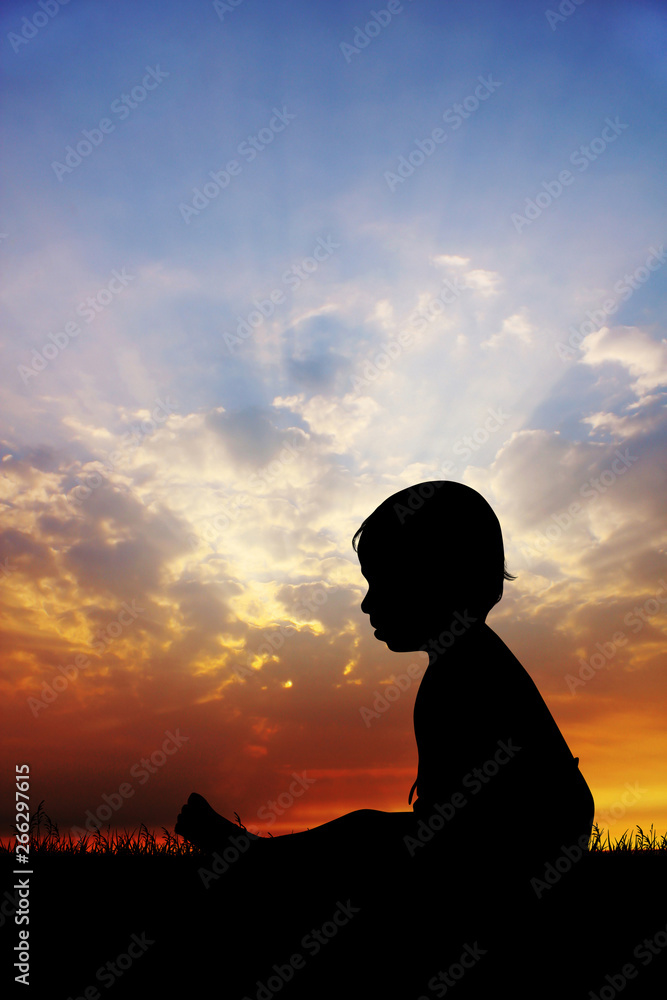 child in the meadow at sunset