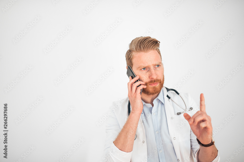 Serious doctor talking on mobile phone. Serious doctor talking on mobile phone.