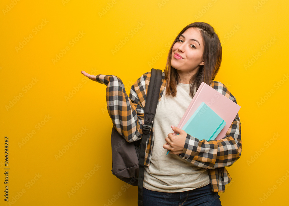Young student woman doubting and shrugging shoulders