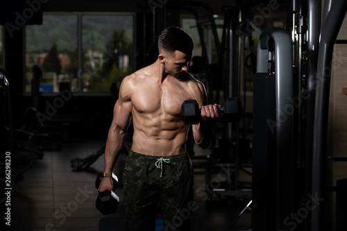 Man With Dumbbells Exercising Biceps