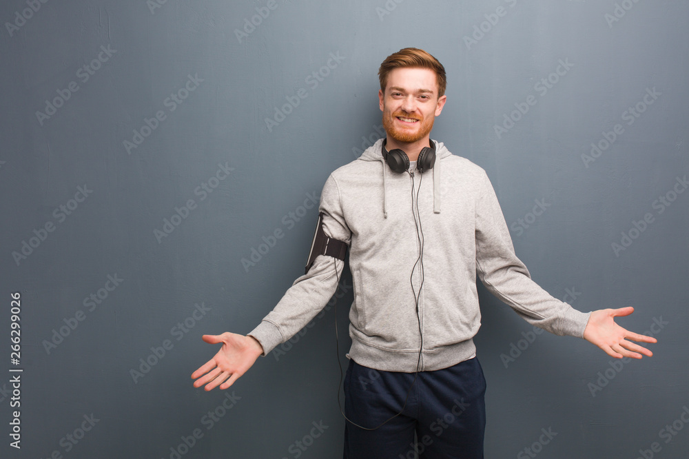 Young fitness redhead man inviting to come Young fitness redhead man inviting to come