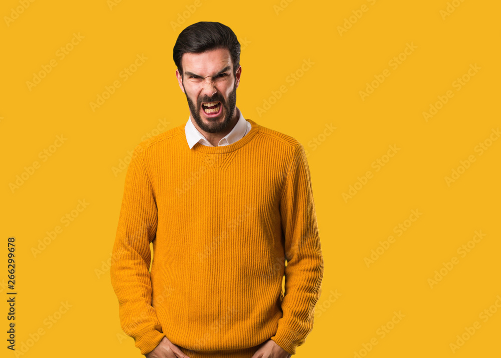 Young natural man screaming very angry and aggressive Young natural man screaming very angry and aggressive
