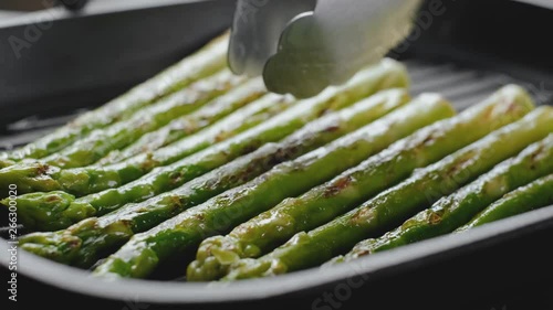 asparagus sprinkled with parmesan cheese fried in a pan