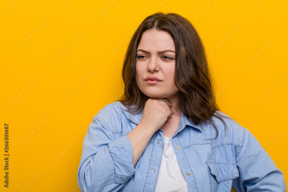 Young curvy plus size woman suffers pain in throat due a virus or infection. Young curvy plus size woman suffers pain in throat due a virus or infection.
