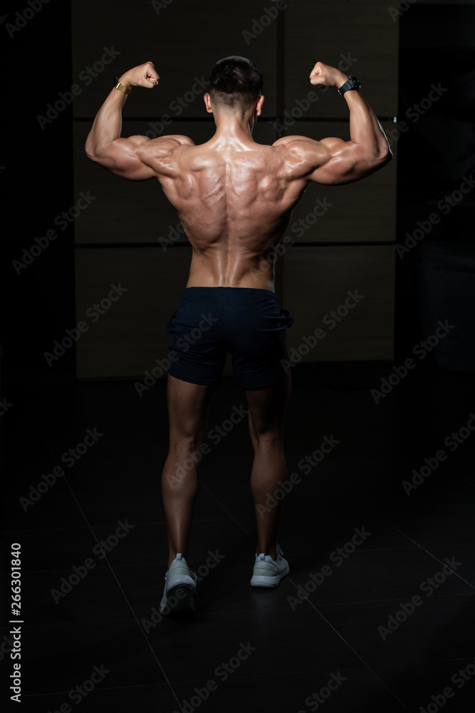 Portrait Of A Young Physically Fit Man Showing His Well Trained Body - Muscular Athletic Bodybuilder Fitness Model Posing After Exercises Portrait Of A Young Physically Fit Man Showing His Well Trained Body - Muscular Athletic Bodybuilder Fitness Model Posing After Exercises