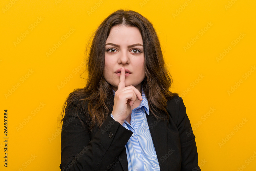 Young plus size caucasian business woman keeping a secret or asking for silence. Young plus size caucasian business woman keeping a secret or asking for silence.