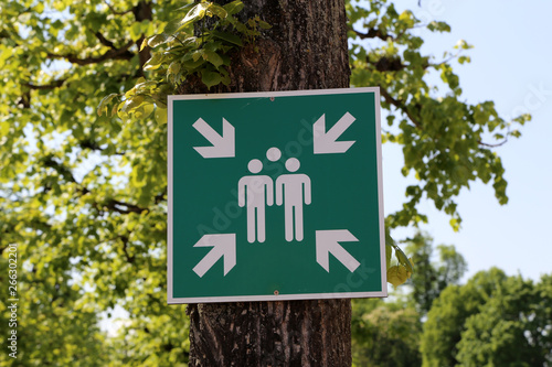 A sign on the tree indicates the gathering place photo