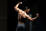 Muscular Man Flexing Muscles Rear Double Biceps Pose