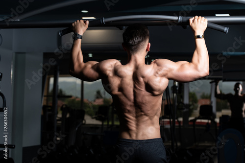 Bodybuilder Doing Pull Ups Best Back Exercises © Jale Ibrak