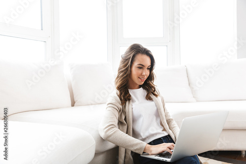 Beautiful young woman working on laptop computer