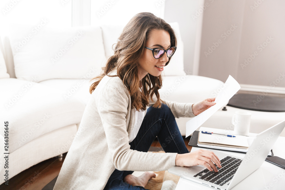 Beautiful young woman working on laptop computer Beautiful young woman working on laptop computer