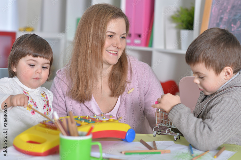 Fototapeta premium Portrait of mother with children playing together