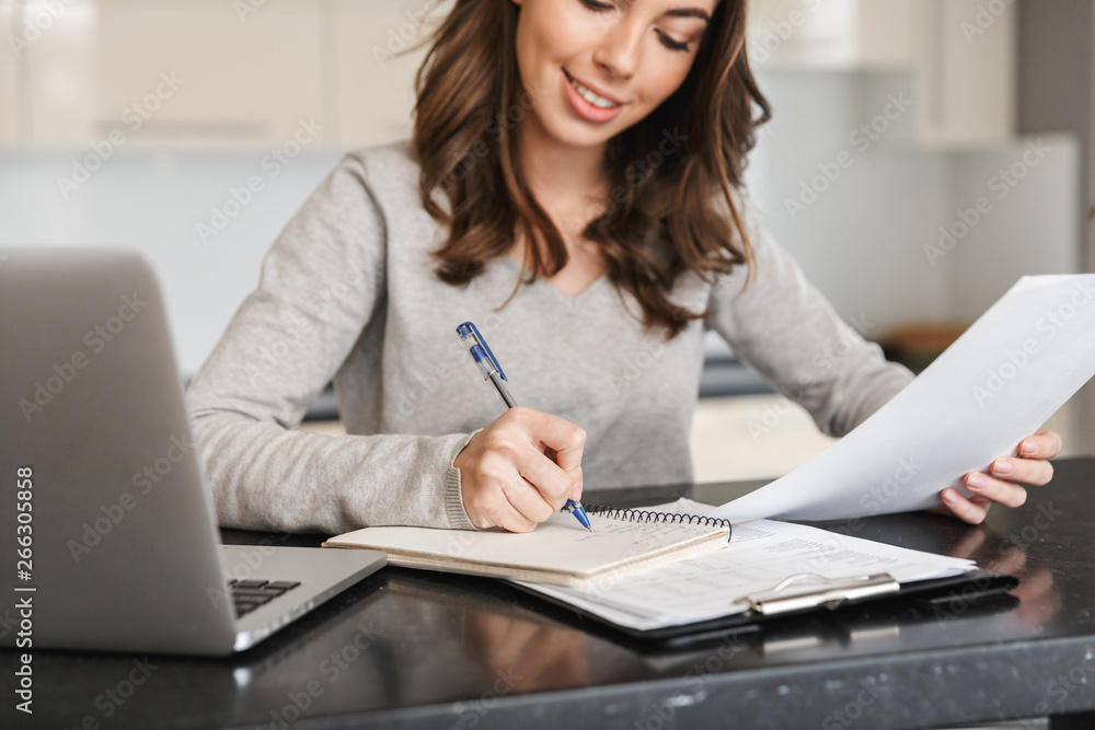 Attractive young woman working on laptop computer Attractive young woman working on laptop computer