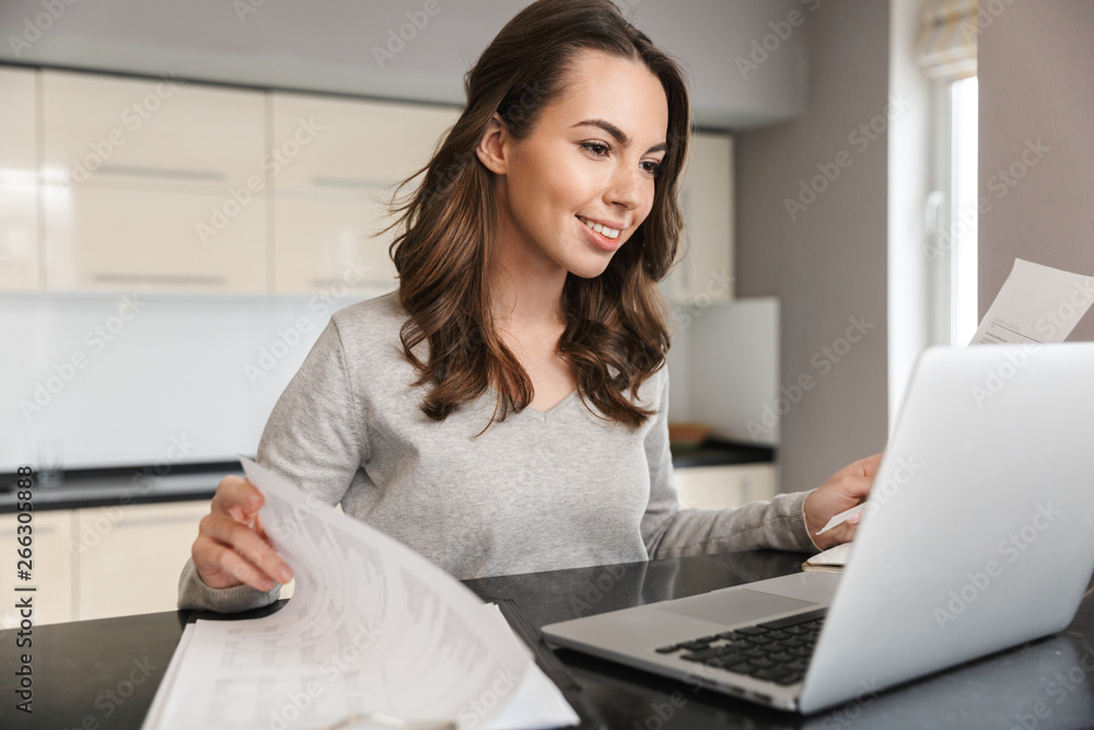 Attractive young woman working on laptop computer Attractive young woman working on laptop computer