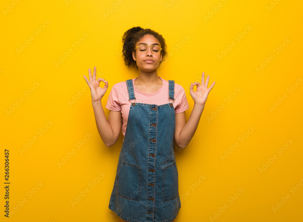 Young black african american girl with blue eyes performing yoga Young black african american girl with blue eyes performing yoga